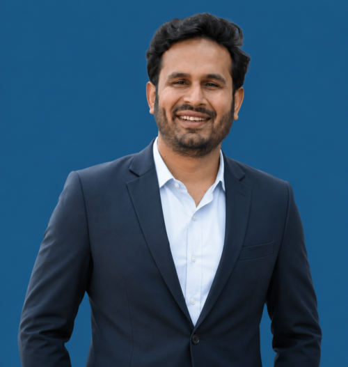 Confident professional portrait on blue background